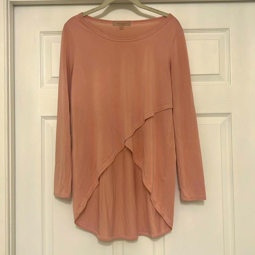 Soft tapered light-pink long-sleeved top.